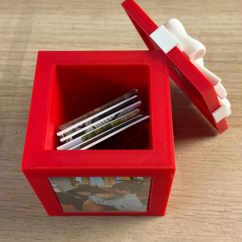 Red Keepsake Box open with photo magnets stored inside