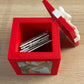 Red Keepsake Box open with photo magnets stored inside