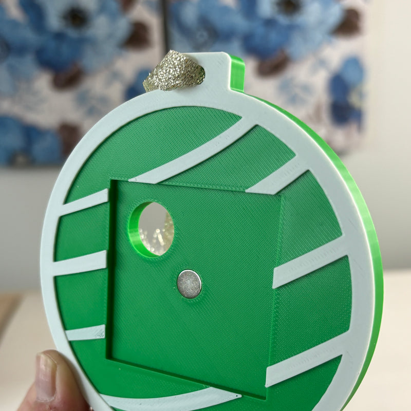 Green Keepsake Ornament without a magnet, showing the magnet spot