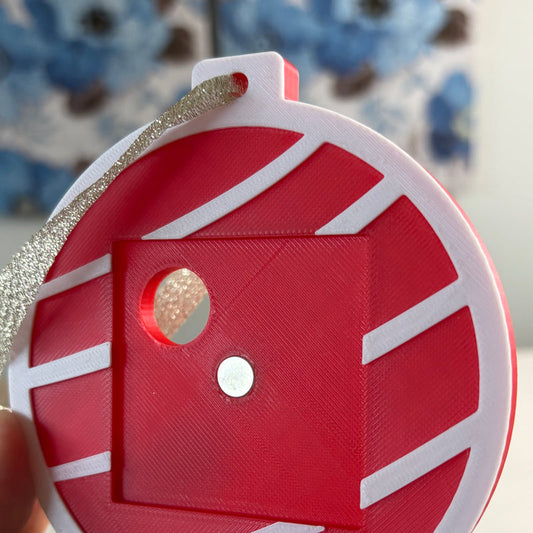 Red Keepsake Ornament without a magnet, showing the magnet spot